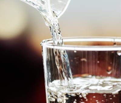 Macro shot of pouring water into a glass
